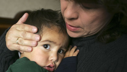 Woman embraces a  child who may be sent back to Mexico