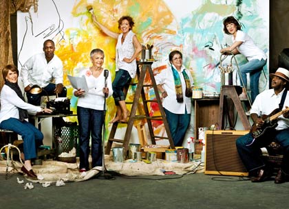 group of creative people in front of painting