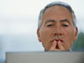 Older man studying a computer screen- online degrees are available for older adults