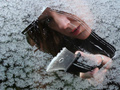 Woman scraping snow off window - cheap ideas for beating the winter blues