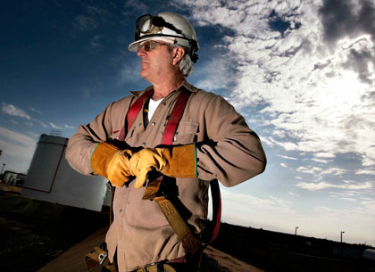 blue collar worker looking out over the horizon