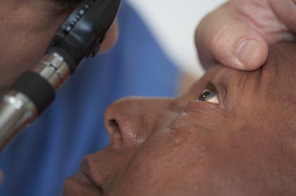 Senior African American man having his eyes examined in a doctor's office