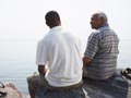 Father and son on rocks by water-how to help adult unemployed children