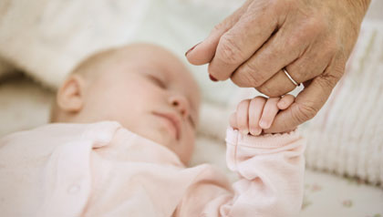 grandparents guide to childproofing holding baby finger