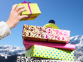 AARP 2011 Holiday Gift Guide- a man holds a stack of christmas presents