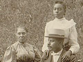 African American family posed for portrait seated on lawn, 1899