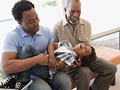 Abuelo y padre jugando con su nieto