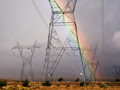 Rainbow over electrical towers