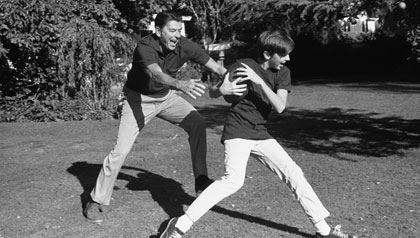 Gov. Ronald Reagan and son, Skipper, both football fans, play touch football in the backyard of their Sacramento home on Nov. 15, 1971.