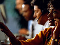 female executive sitting at computer, using telephone headset