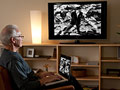 How to watch internet video on tv, man with laptop, Apple TV