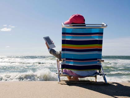 using an e reader at the beach using an e reader at the beach