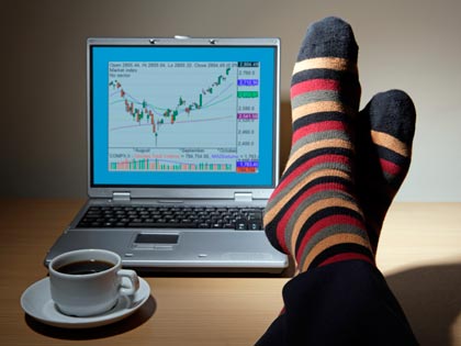 feet up on a desk with coffee cup and laptop feet up on a desk with coffee cup and laptop