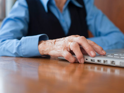 elderly woman using a laptop elderly woman using a laptop