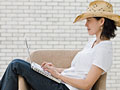 Self publishing a book is becoming easier with ebooks - a woman types on her laptop