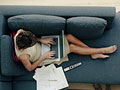 How to install a wireless network in your house - a woman uses her laptop computer on the sofa