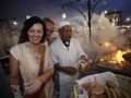Couple eating food at a market in Marrakesh, Morocco.
