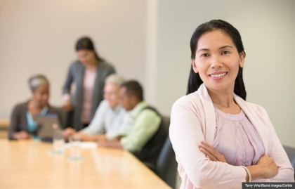 Woman in conference room, Social Security helping people to return to work. (Terry Vine/Blend Images/Corbis)