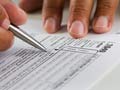 hands filling in a tax form