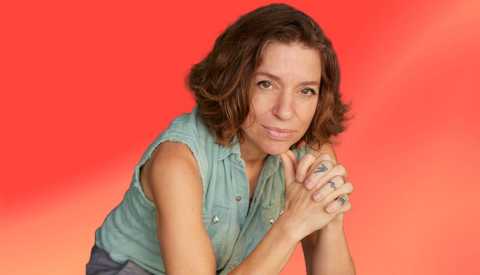 ani difranco against peach-colored ombre background