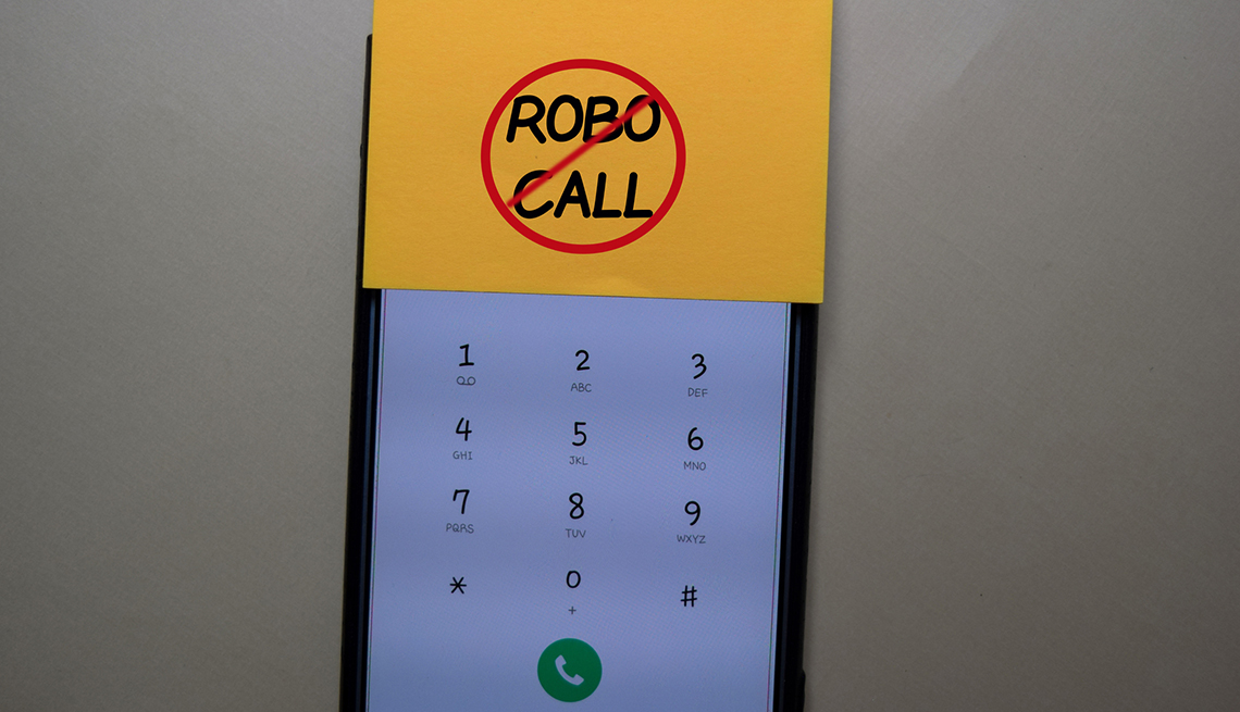 the screen of a mobile phone with a sticky note on it that says no robo calls