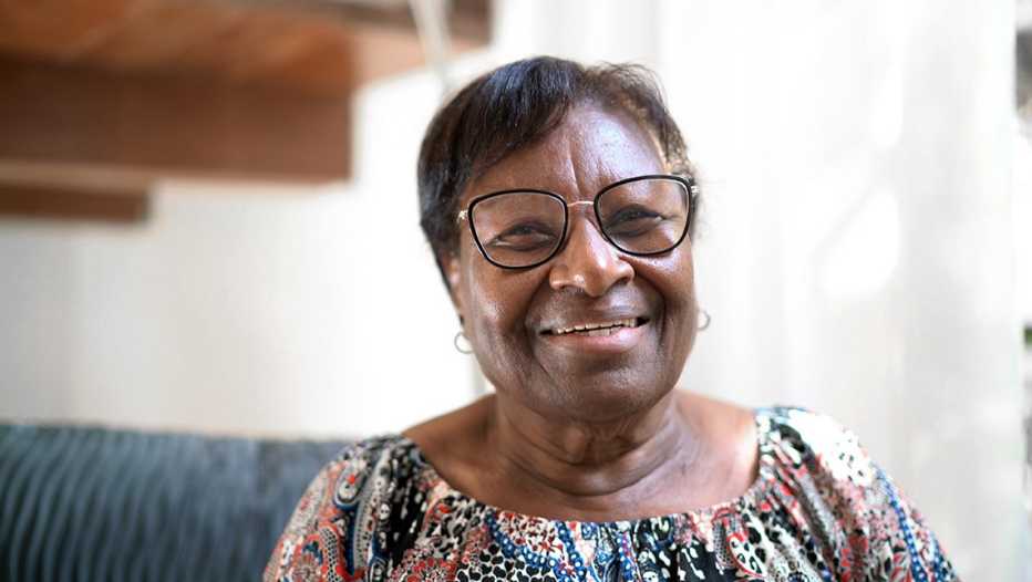 African American woman wearing glasses and smiling