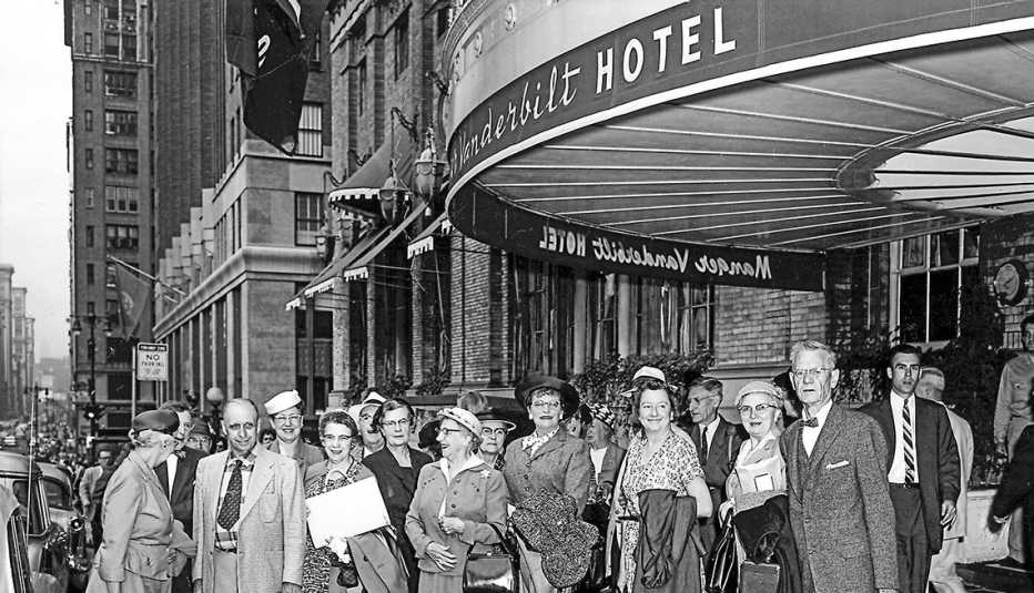 Group of people standing outside the Vanderbilt Hotel in New York City.