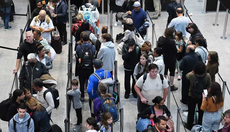 passengers in a crowded TSA line at the Orlando Airport in December 2022.