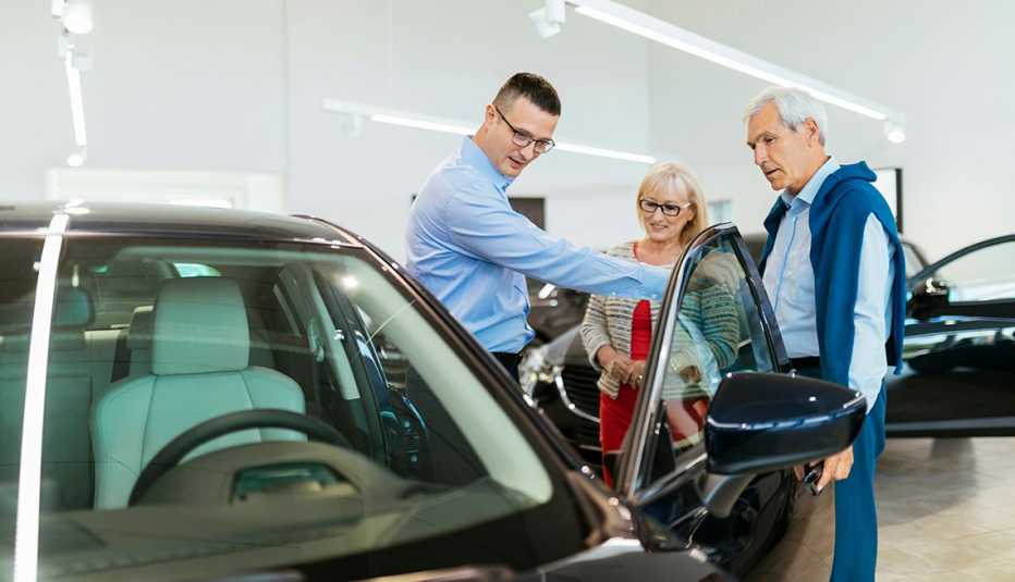 boomers shopping for a new in with salesman in a dealership