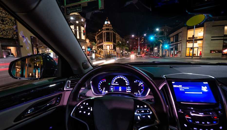 the dashboard of a luxury car driving through a city