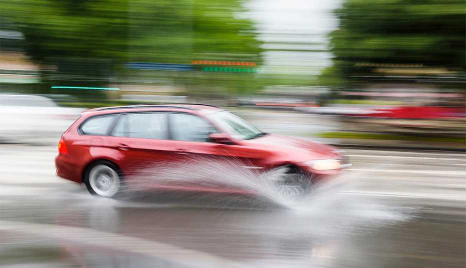 red car on a wet roadway