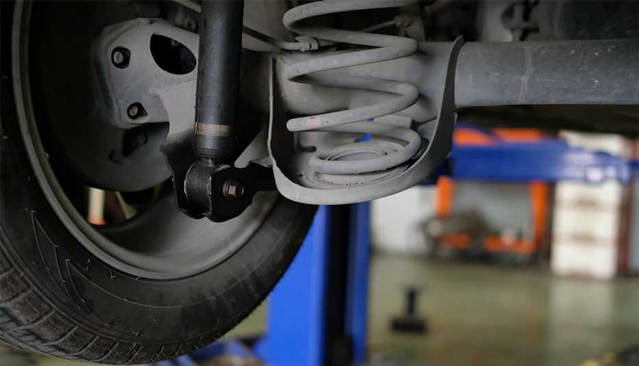 damaged rear car shock absorber & spring in auto service repair garage