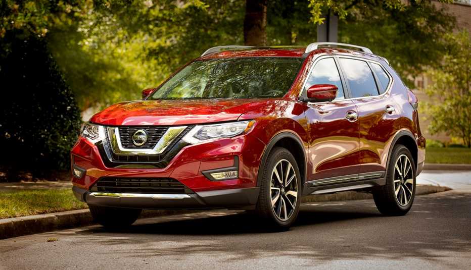 Maroon 2019 Nissan Rogue parked on a leafy street