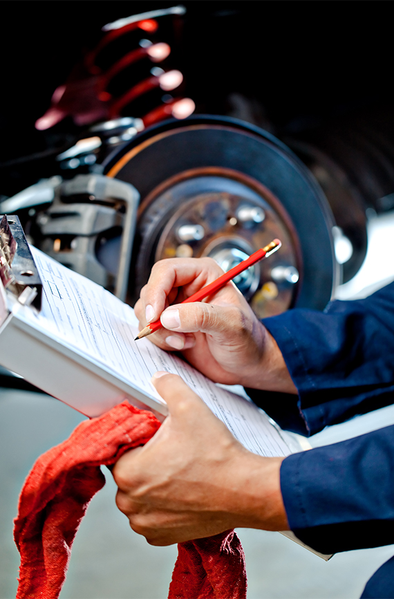 mechanic writing an auto estimate for repair work