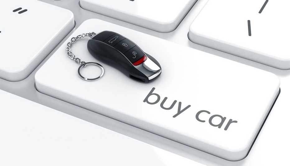 3d rendering of luxury car key with remote control on the computer keyboard