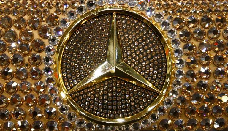 crystal studded mercedes benz logo closeup on a car steering wheel