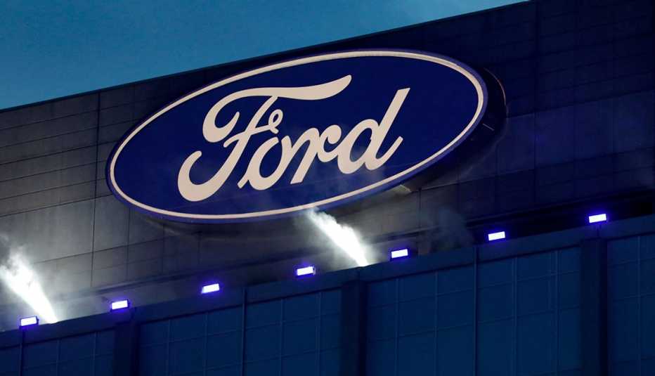 a ford sign lit up on a building exterior