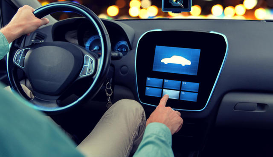 Man using touchscreen dashboard in car