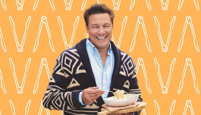 Rocco DiSpirito against orange background with outlines of tongs on it