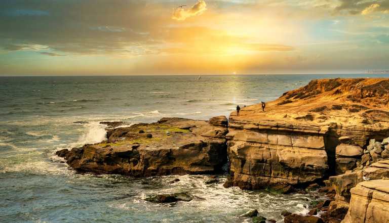 San Diego's Sunset Cliffs Natural Park with the  sun setting over the water