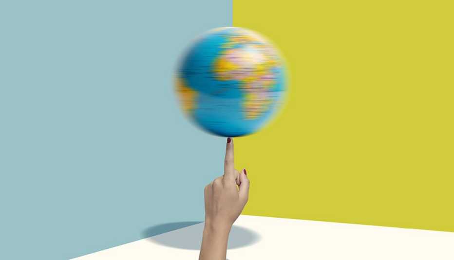 spinning globe on a woman's index finger