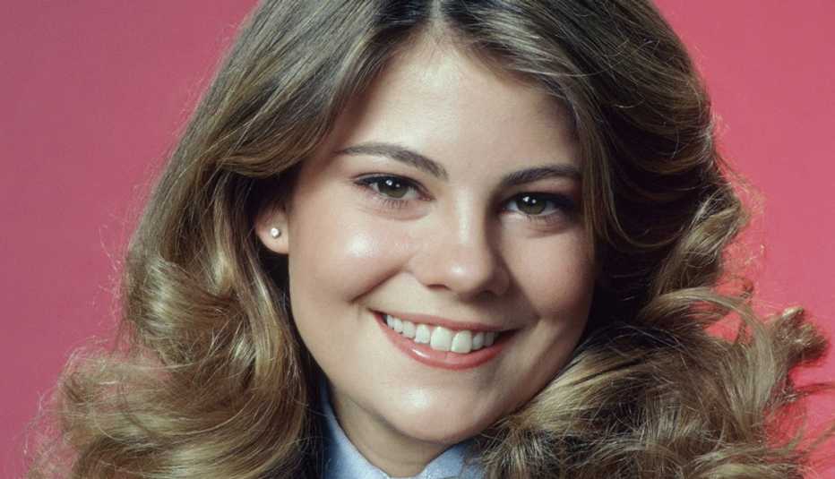 TV actress Lisa Whelchel poses in front of a pink background in the 1980s