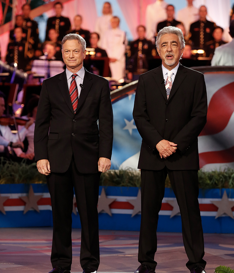 Actors Gary Sinise and Joe Mantegna stand on stage