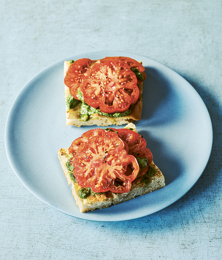 tomatoes and pesto on toast on plate