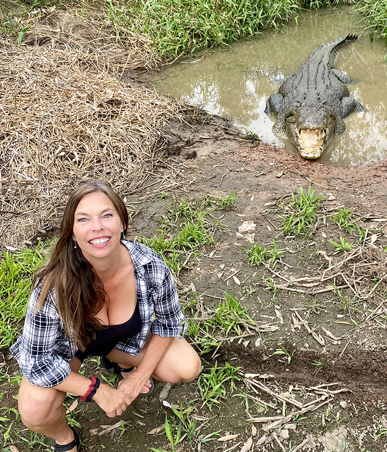 heide brandes crouching down in front of a crocodile