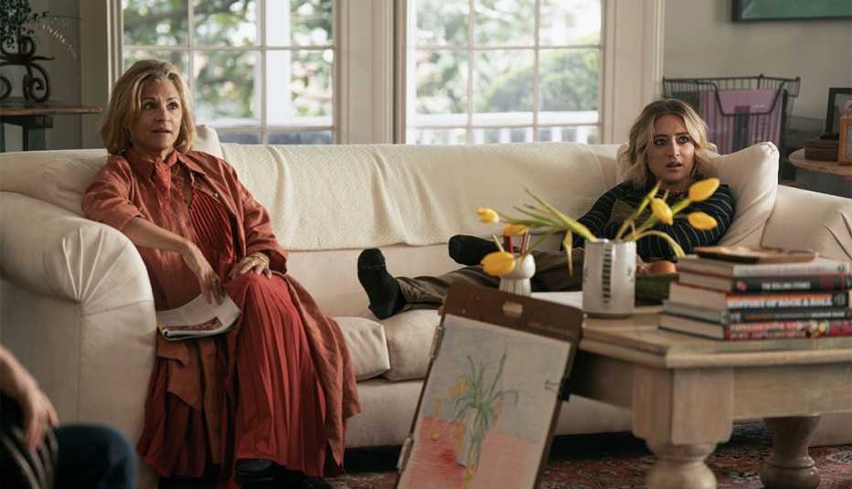 amy sedaris and lizze broadway sitting on couch in still from ghosted