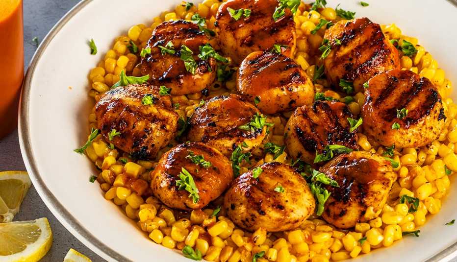 grilled scallops and corn on plate
