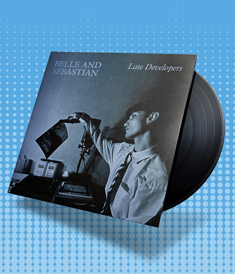 album cover with record sticking out of it; cover says belle and sebastian, late developers; cover shows person holding picture; blue background with little shapes on it