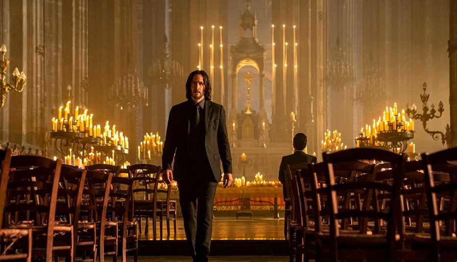 keanu reeves as john wick and donnie yen as caine in a church in still from john wick chapter four