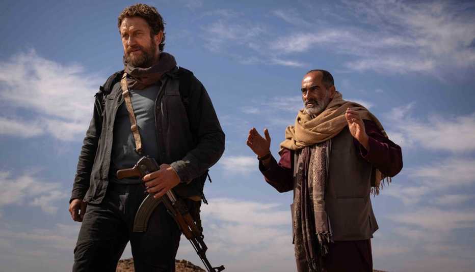 gerard butler and navid negahban under blue sky with little white clouds in still from kandahar